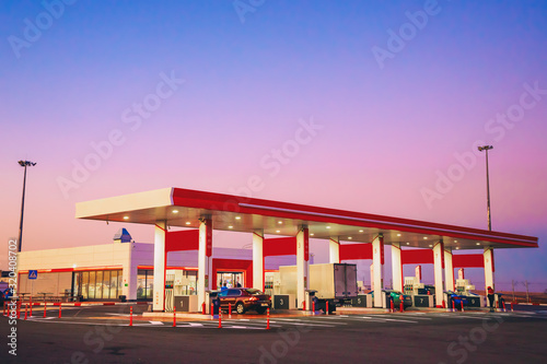 modern car gas station with cars on the background of a beautiful sunset or dawn