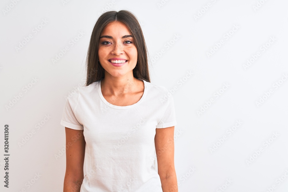 Young beautiful woman wearing casual t-shirt standing over isolated white background with a happy and cool smile on face. Lucky person. Young beautiful woman wearing casual t-shirt standing over isolated white background with a happy and cool smile on face. Lucky person.