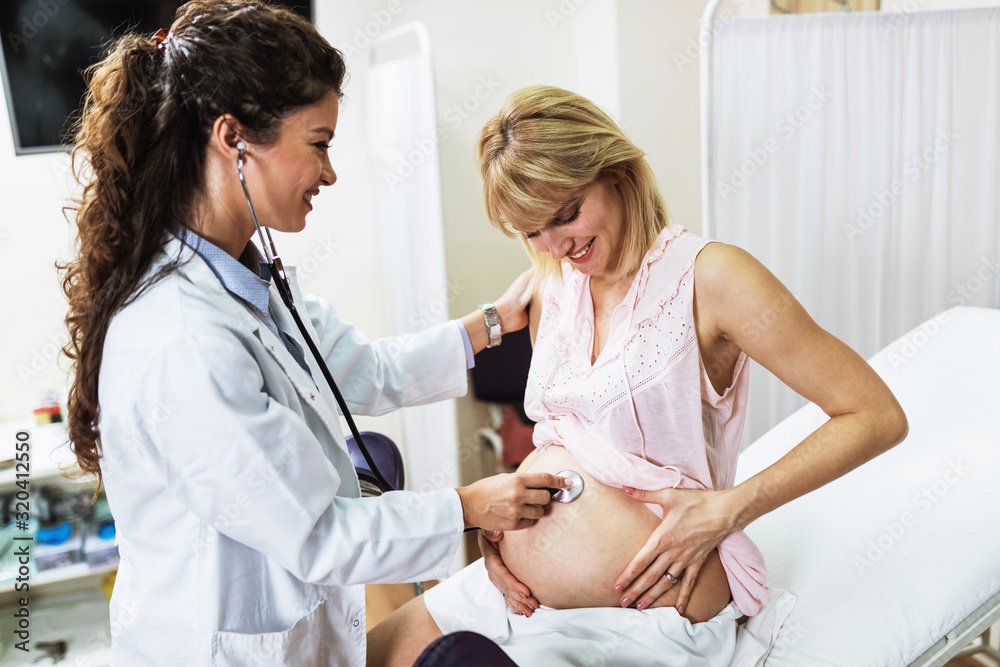 Gynecology examination and consultation. Pregnant woman with her doctor at clinic. Gynecology examination and consultation. Pregnant woman with her doctor at clinic.