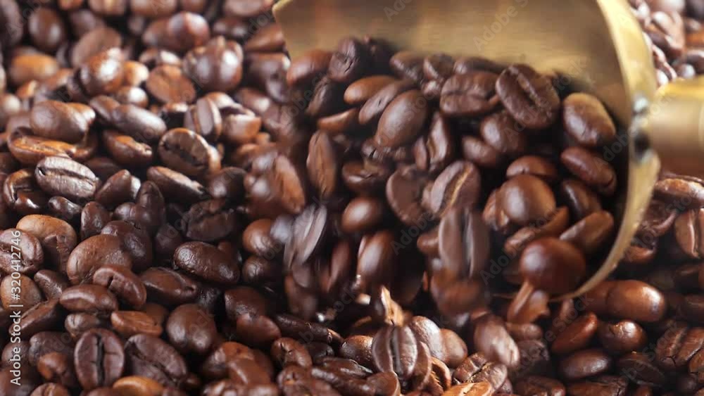 The coffee beans are roasted and mixed with a spoon. The coffee beans are roasted and mixed with a spoon.