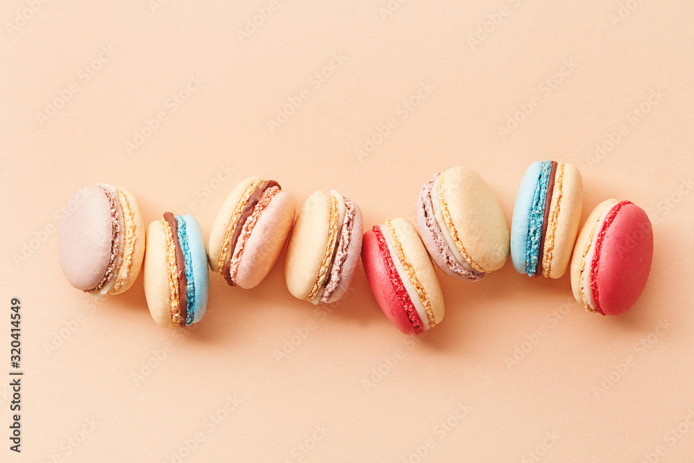 Macarons on colored background. Sweet and colourful french macaroons. Composition of macarons
