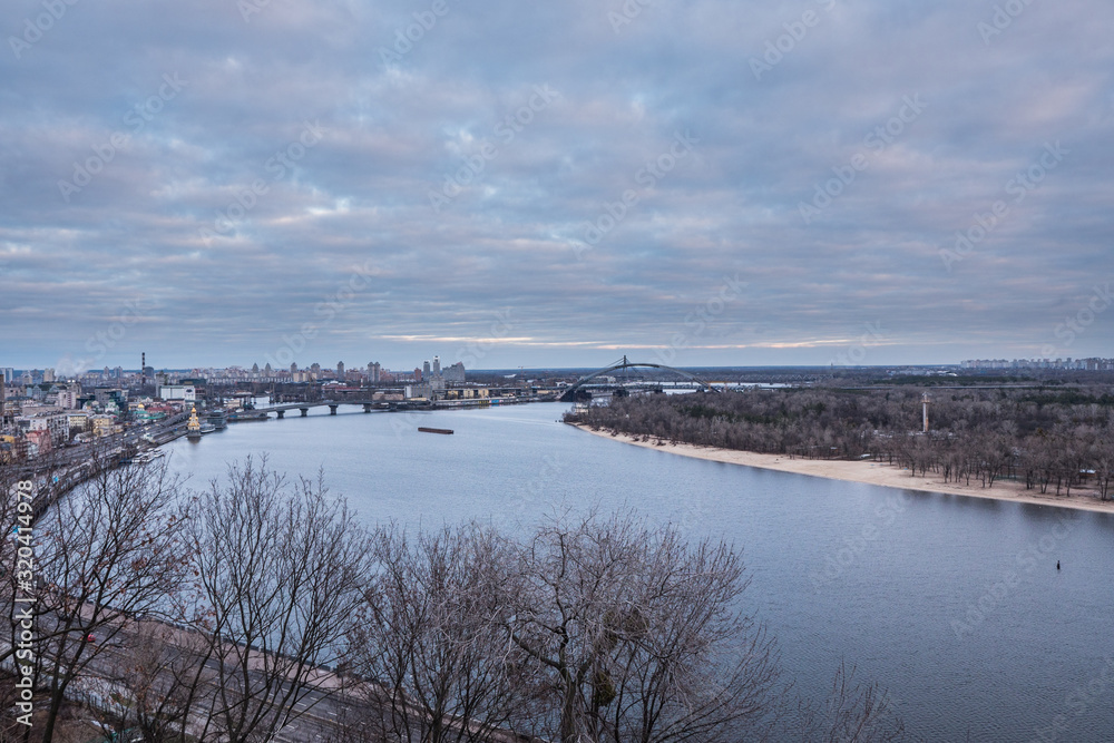 Kyiv, winter morning, beautiful view to the historical center Podol. Dnipro river, cloudy sky. High quality photo.