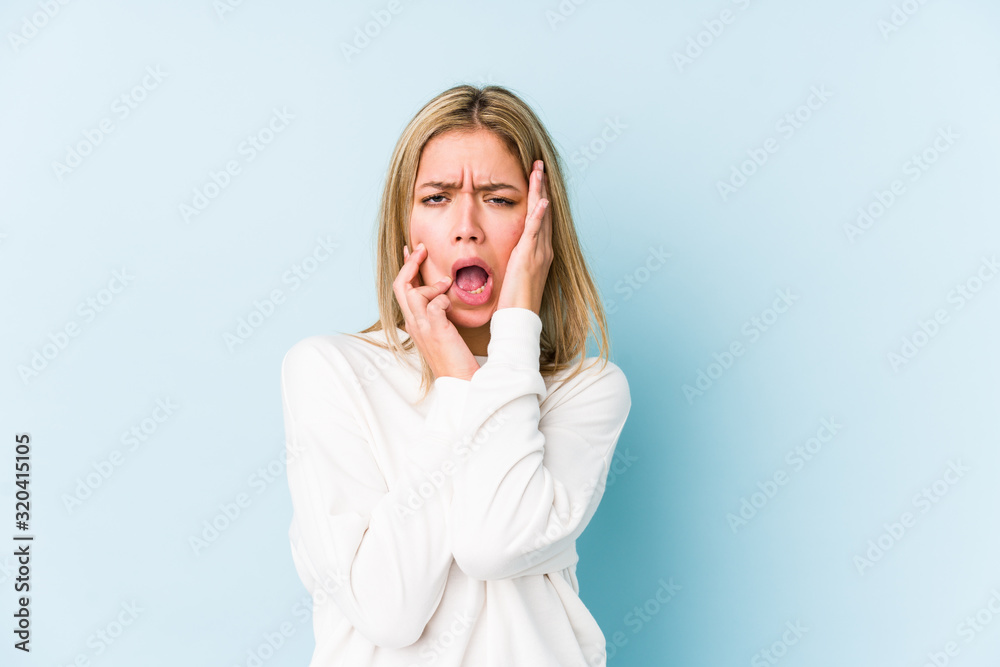 Young blonde caucasian woman isolated whining and crying disconsolately. Young blonde caucasian woman isolated whining and crying disconsolately.