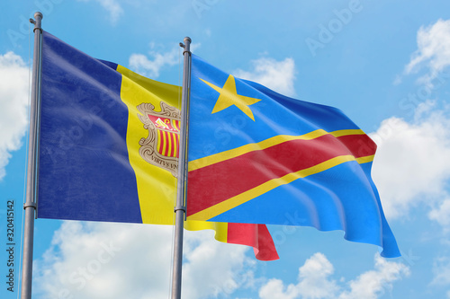 Congo and Andorra flags waving in the wind against white cloudy blue sky together. Diplomacy concept, international relations.