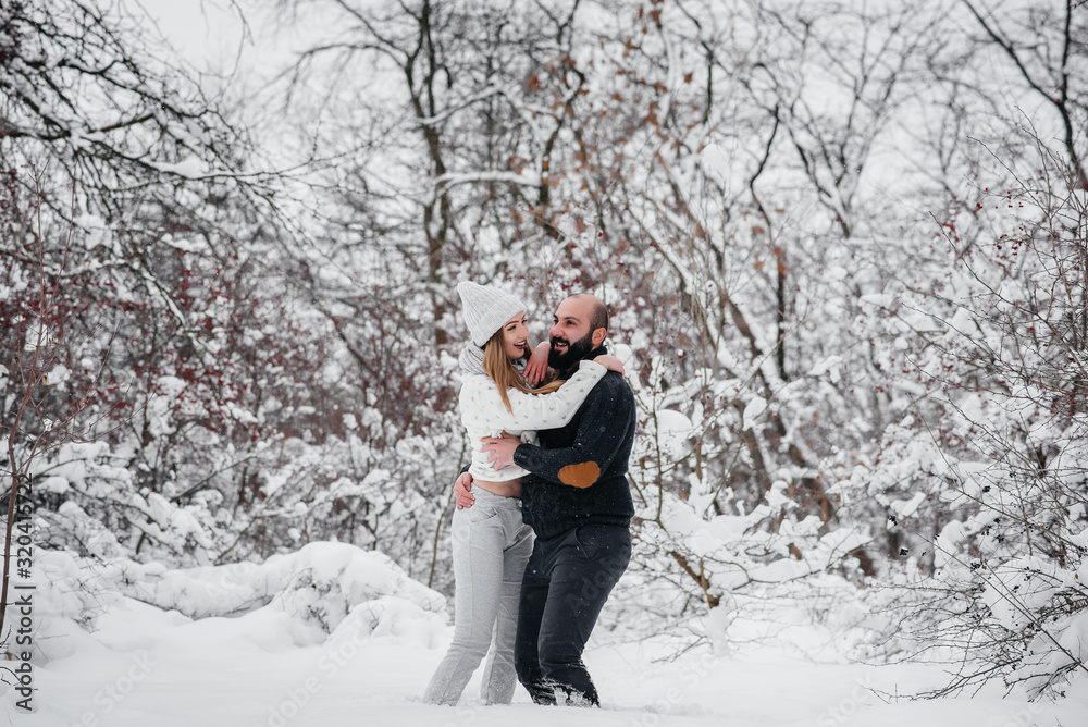 Couple playing with snow in the forest Couple playing with snow in the forest