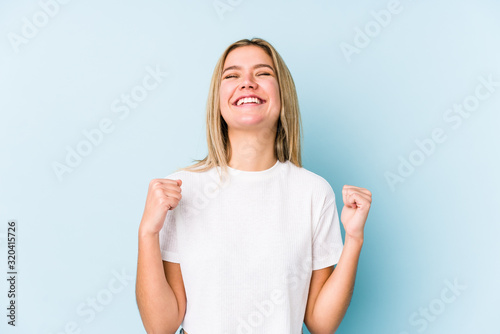 Obraz na plátně Young blonde caucasian woman isolated celebrating a victory, passion and enthusiasm, happy expression