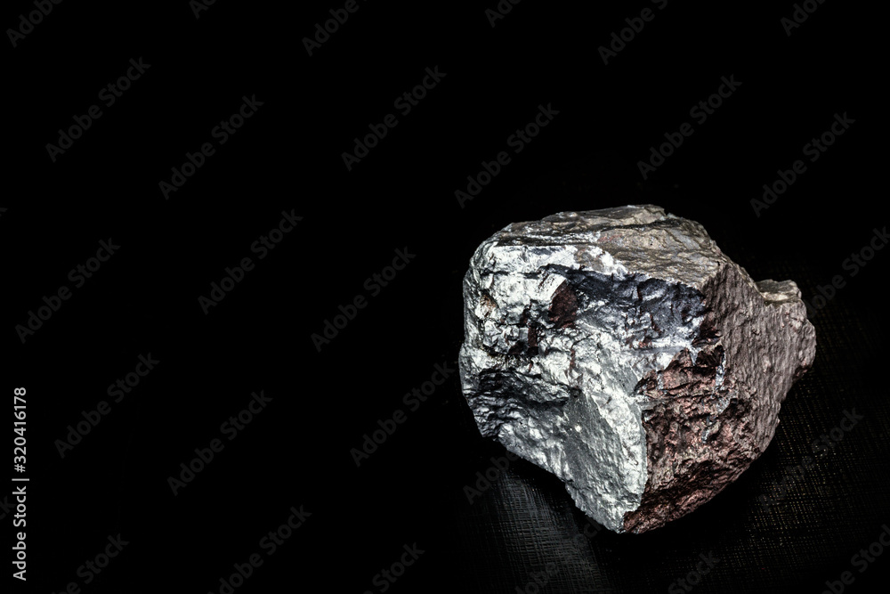 big big silver nugget on black background. Raw silver stone, silver nugget native to Liberia, isolated on black background. Mineral extraction.