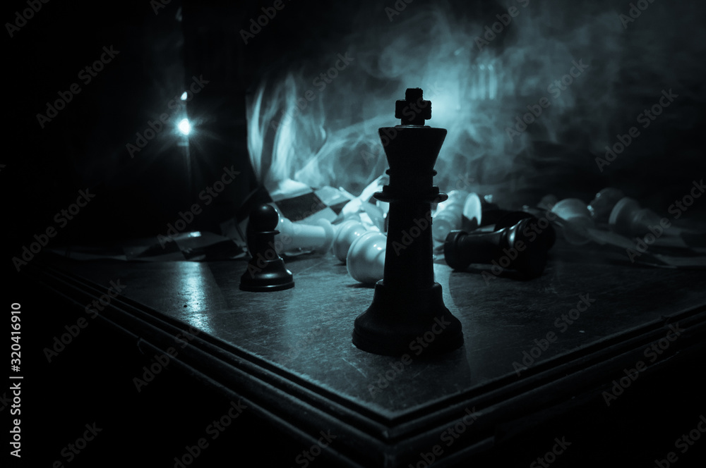 Chess figures on a dark background with smoke and fog. Epic chess