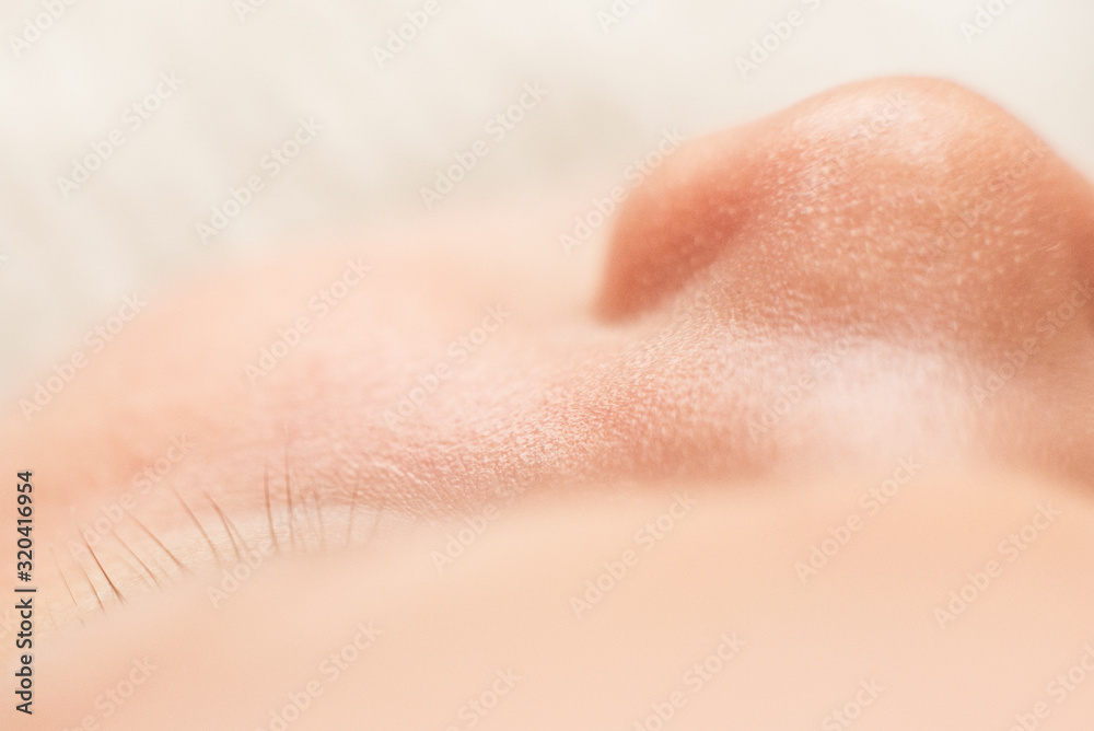 Fototapeta premium nose of newborn baby, maternal care, love and family hugs, tenderness, macro shoot