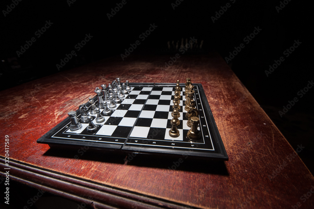 Chess figures on a dark background with smoke and fog. Selective focus Chess figures on a dark background with smoke and fog. Selective focus
