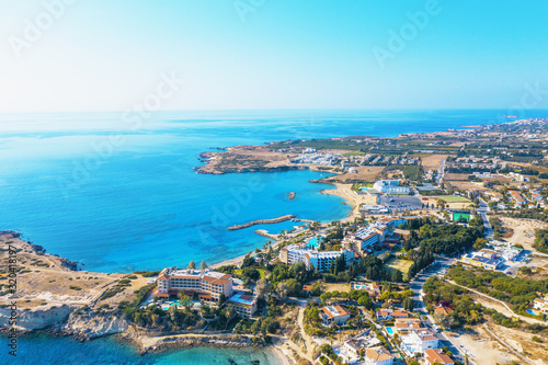 Aerial panoramic view of Cyprus landscape with hotels, bays with beaches and clear mediterranean sea water. Travel to Cyprus concept with copy space.