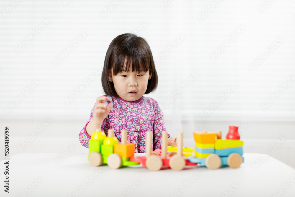 toddler girl playing creative toy blocks at home against white background toddler girl playing creative toy blocks at home against white background