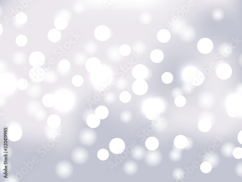 White and silver bokeh background. Holiday glowing white lights with sparkles. Festive defocused lights. Blurred bright abstract bokeh on light background.