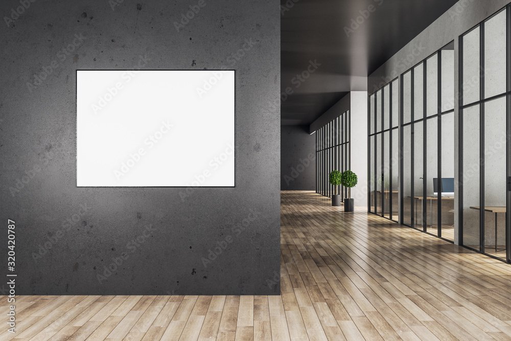 Office interior with blank billboard on gray concrete wall.