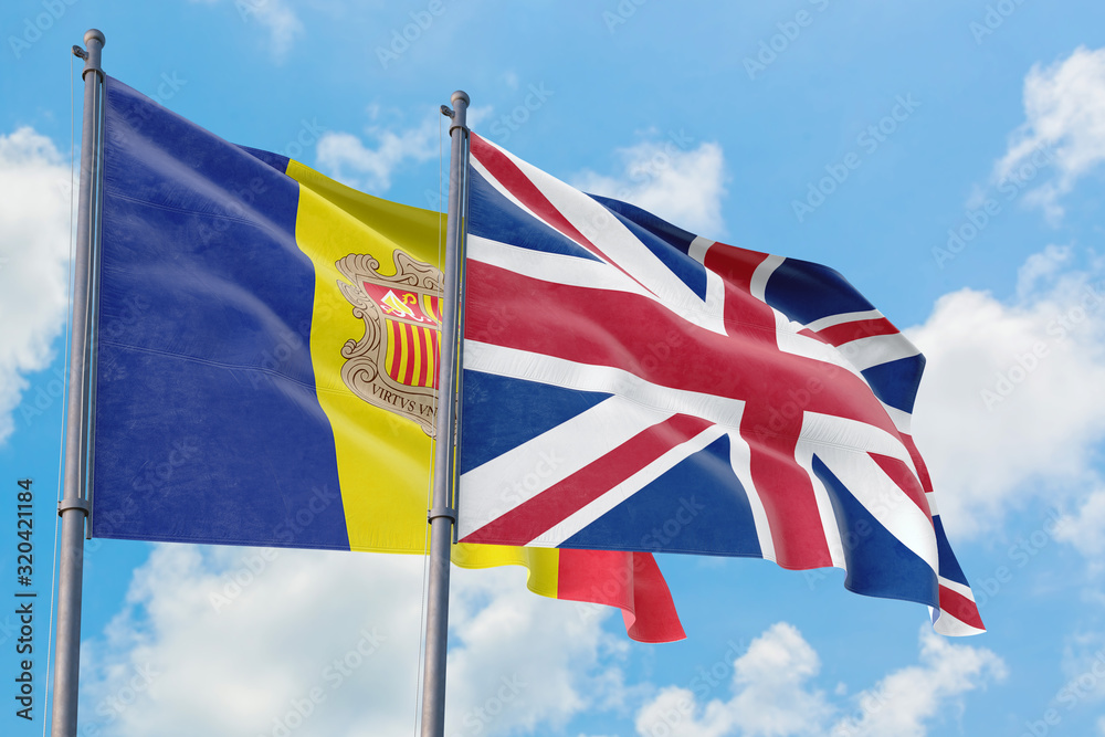United Kingdom and Andorra flags waving in the wind against white cloudy blue sky together. Diplomacy concept, international relations.