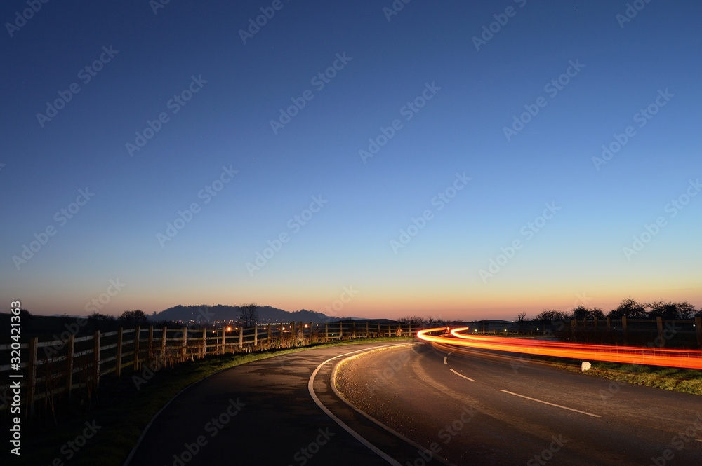 Fototapeta premium Car zooming in the Sunset