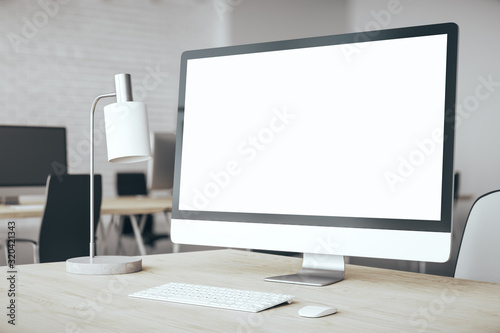 Designer desktop with empty white computer screen photo