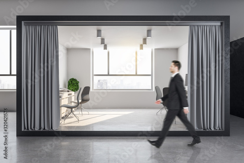 Businessman walking in luxury office interior room