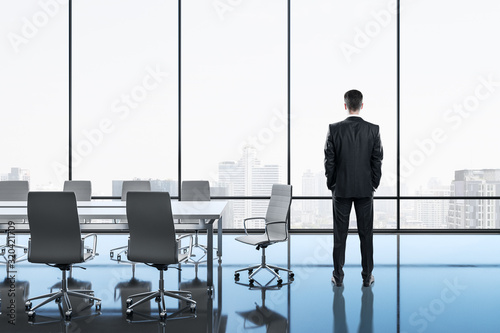 Businessman standing in meeting room
