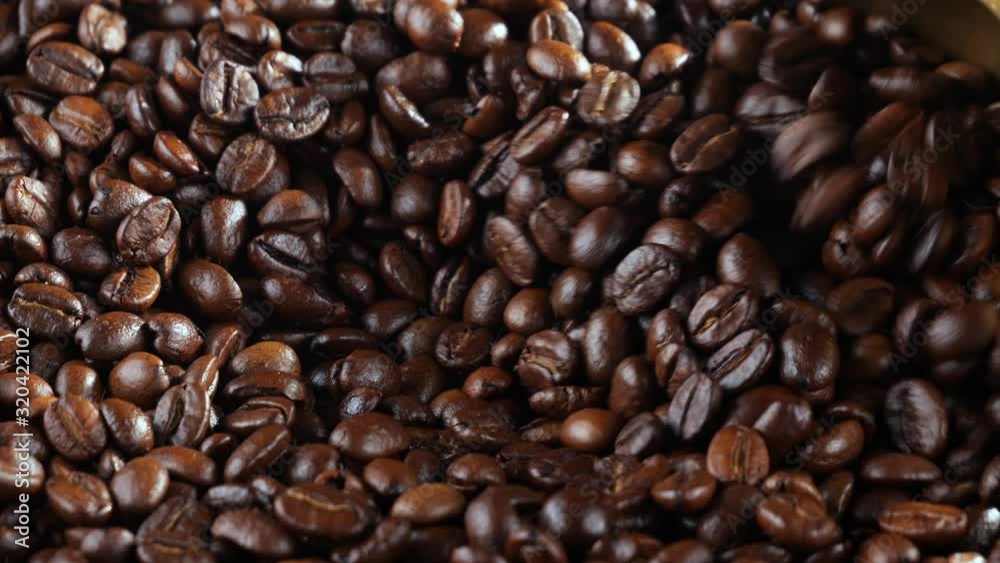 The coffee beans are roasted and mixed with a spoon. The coffee beans are roasted and mixed with a spoon.