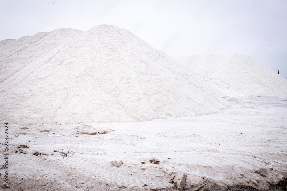 Close up of mountain, pile of fresh salt and tracks on ground by the Tuz, central anatolia, Turkey. Salt industry and product from natural salt reservoir.