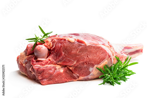 Fresh raw lamb leg with rosemary leaves isolated on white photo