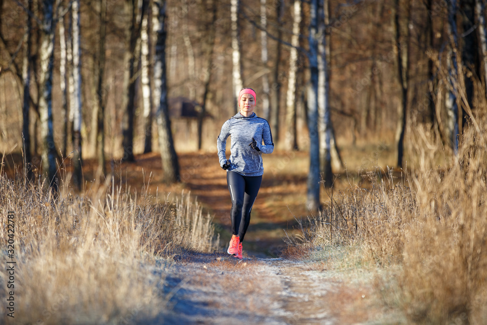 Young woman running training in autumn park Young woman running training in autumn park