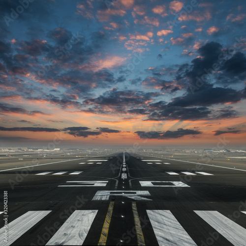 airport runway with beautiful cloudy sky photo