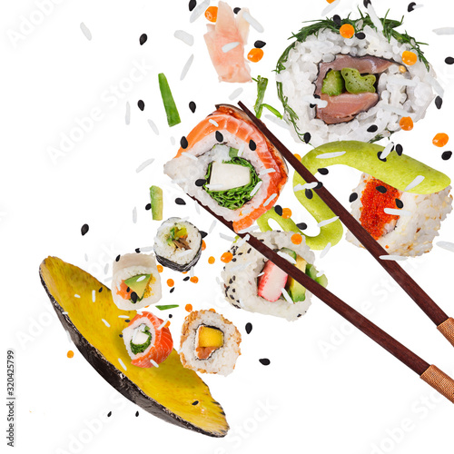 Pieces of delicious japanese sushi frozen in the air. Isolated on white background