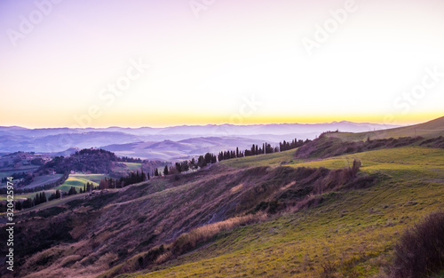 Tuscany hills countryside Italian landscape colorful at sunset. Italy.