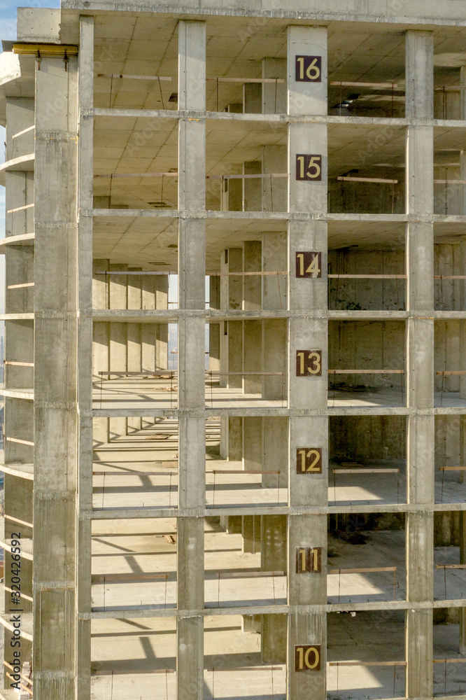 Aerial view of concrete frame of tall apartment building under construction in a city Aerial view of concrete frame of tall apartment building under construction in a city