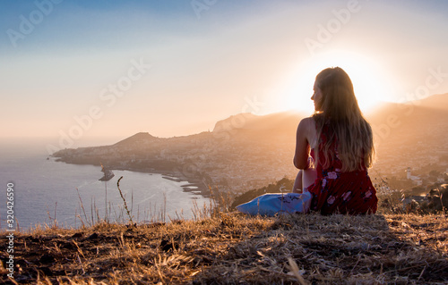 Sunset view person hiking madeira miradouro looking over bay of Funchal outdoor traveling concept