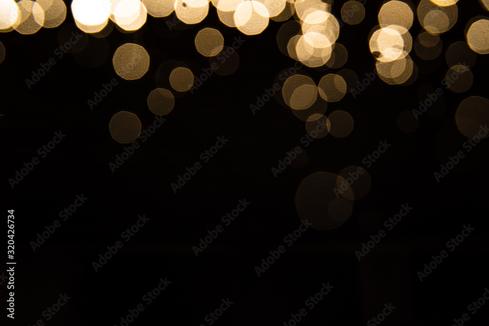 Abstract gold bokeh with black background - obrazy, fototapety, plakaty 