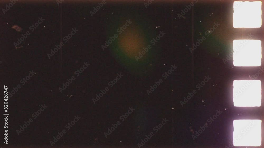 Film noise or grain seamless texture. Retro template. 35mm negative film on scanner lamp. Scratched strip. Old tape looped animation in 4K. Vintage film effect