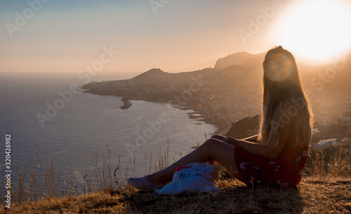 Sunset view person hiking madeira miradouro looking over bay of Funchal outdoor traveling concept