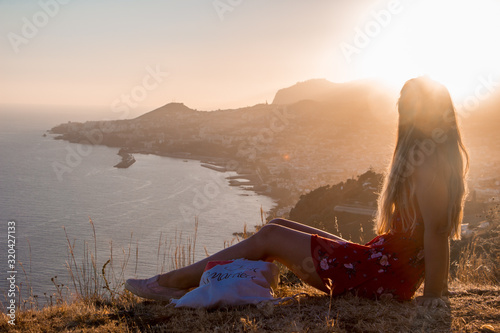 Sunset view person hiking madeira miradouro looking over bay of Funchal outdoor traveling concept