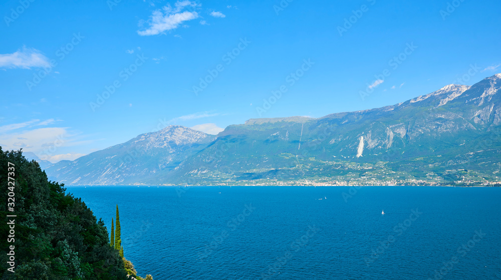 Panorama of the gorgeous Lake Garda surrounded by mountains in Riva del Garda, Italy.