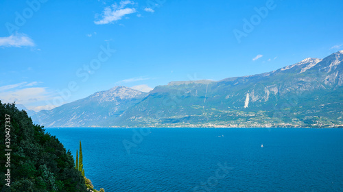 Panorama of the gorgeous Lake Garda surrounded by mountains in Riva del Garda, Italy.