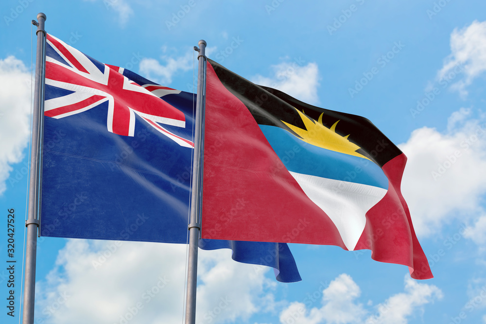 Antigua and Barbuda and Anguilla flags waving in the wind against white cloudy blue sky together. Diplomacy concept, international relations.