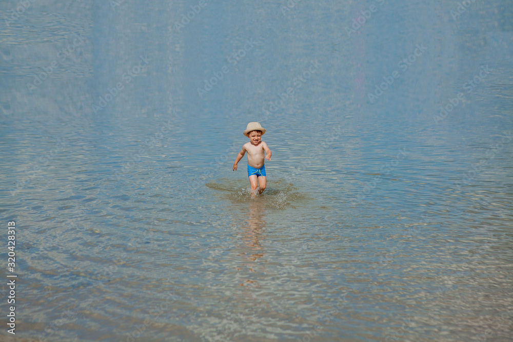 happy baby running from surf on the beach happy baby running from surf on the beach