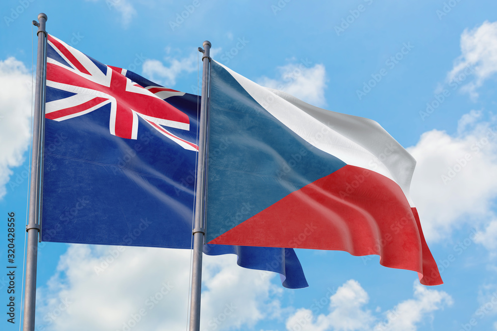 Czech Republic and Anguilla flags waving in the wind against white cloudy blue sky together. Diplomacy concept, international relations.