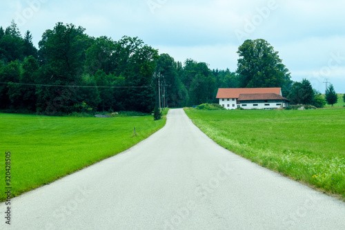 Baviera / Germany - July 28, 2019: Road in the green field at south of Germany