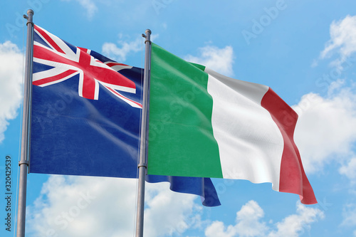Italy and Anguilla flags waving in the wind against white cloudy blue sky together. Diplomacy concept  international relations.
