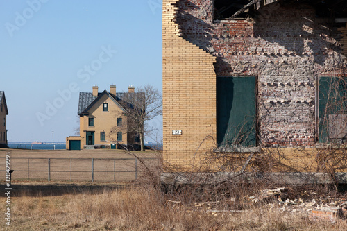 A view of some of the dilapidated buildings at Fort Hancock in Sandy Hook, New Jersey. Officers Row can be seen in the background. photo