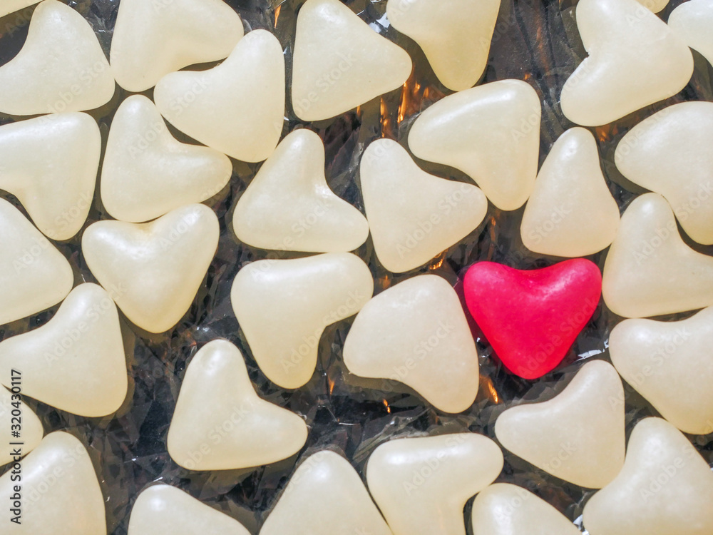 One red heart sweet jelly between white hearts. Concept the one, unique. love. Warm tone, One red heart sweet jelly between white hearts. Concept the one, unique. love. Warm tone,