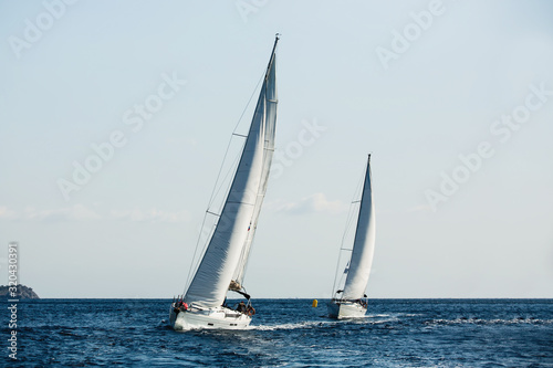Yachts ship with white sails in the Sea at sailing regatta..