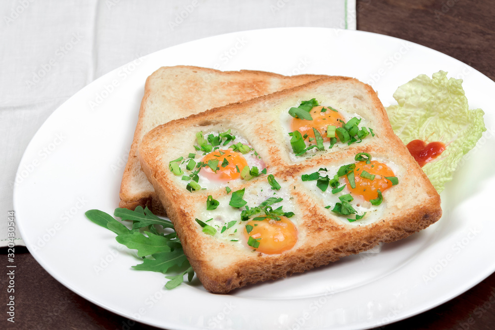 Fried scrambled quail eggs and bread in the shape of 4 hearts (like lucky clover) with toasts and fresh vegetables served on a wooden table. Creative breakfast on Valentine's or Mother's Day, closeup Fried scrambled quail eggs and bread in the shape of 4 hearts (like lucky clover) with toasts and fresh vegetables served on a wooden table. Creative breakfast on Valentine's or Mother's Day, closeup