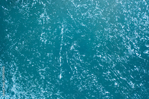 The texture of thick ice on the lake, drone view.