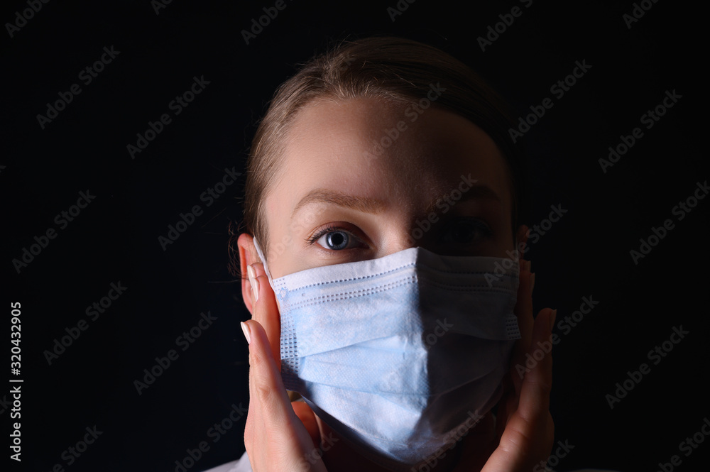 Man in a mask, on a black background with red light. Epidemi, dangerous corona virus 2020 Man in a mask, on a black background with red light. Epidemi, dangerous corona virus 2020