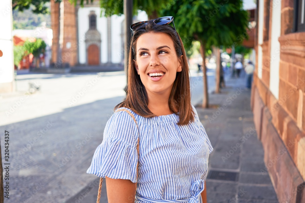 Young beautiful woman on romatic village walking on the town street on a sunny day Young beautiful woman on romatic village walking on the town street on a sunny day